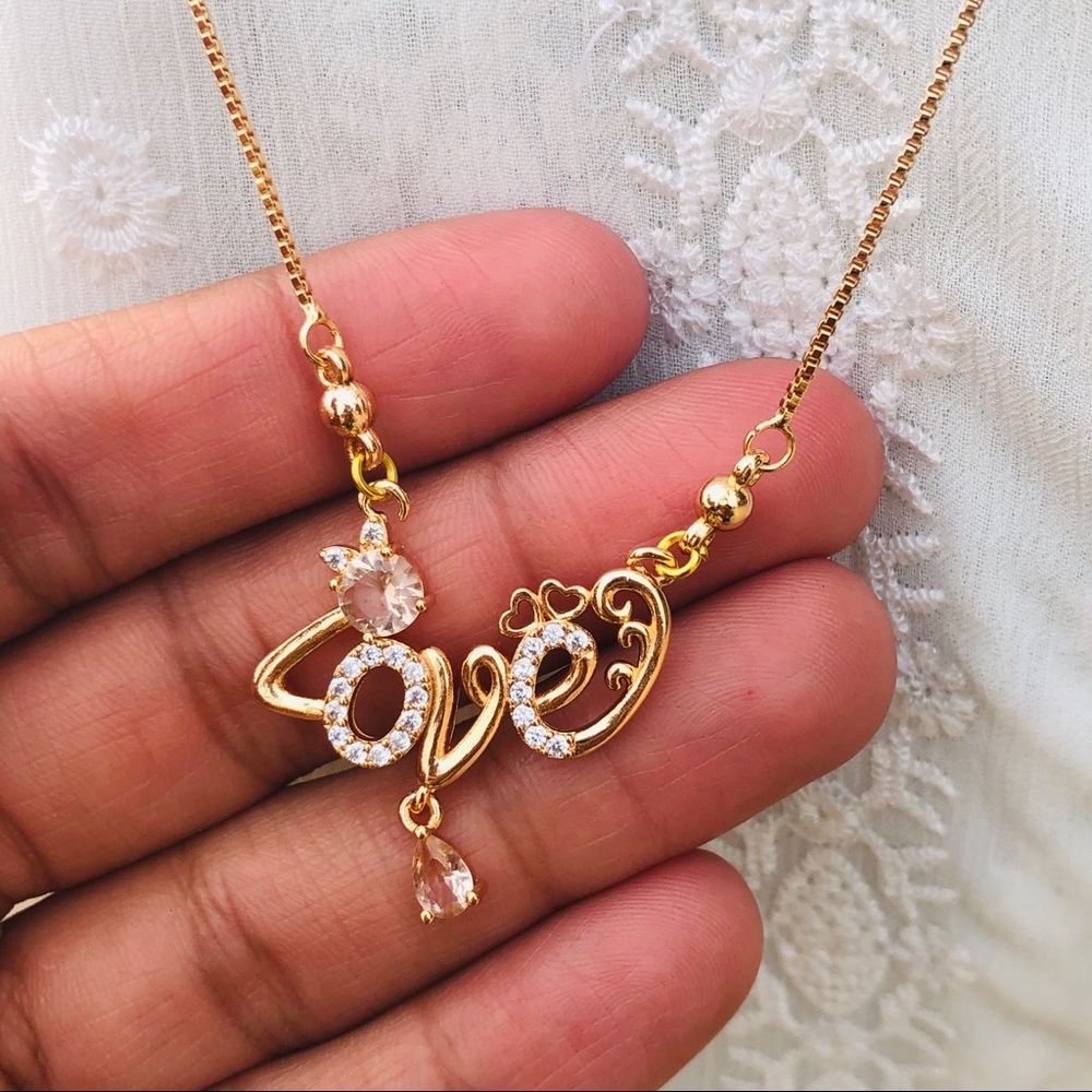 Golden necklace with love written in it